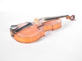 a violin that is sitting on a white surface
