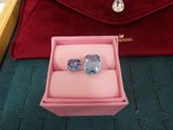 a pink box with a pair of earrings in it