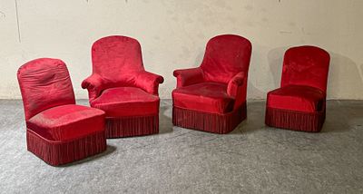 three red chairs and a ottoman in a room with a wall in the background