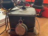 a black telephone sitting on top of a wooden table