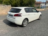 a white car that is parked on the side of the road
