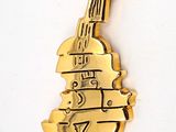 a gold plated violin brooch on a white surface