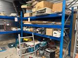 many boxes and tools on the shelves in the garage