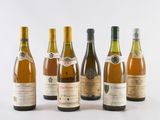 several bottles of wine are lined up on a white surface