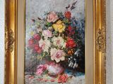 painting of a vase of flowers in a gold frame on a white wall