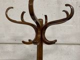 a wooden coat stand with a coat rack on it