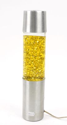 a silver and yellow lamp that is sitting on a table