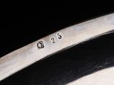 an image of a close up of a silver plate with numbers on it