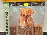 a bag of dog food with a golden retriever sitting on top of it