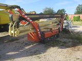 a crane that is sitting in the dirt near a truck