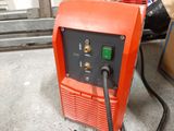 an orange machine that is sitting on the floor