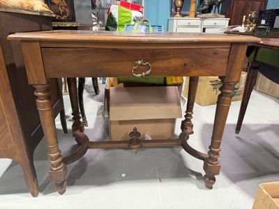 a wooden table with a drawer on top of it