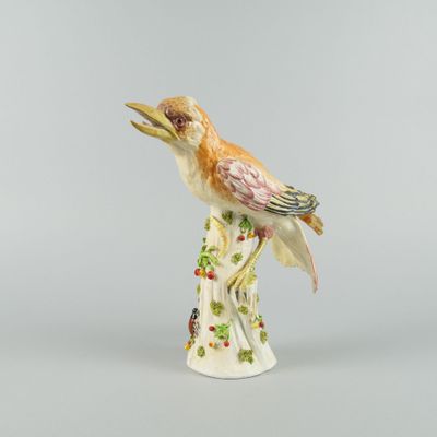 porcelain figurine of a bird perched on a tree branch