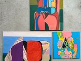 three paintings of different shapes and colors are hanging on a wall