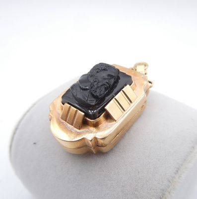 an image of a gold ring with a black stone in the center