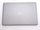 dell laptop computer sitting on a white surface with a dell logo on the screen
