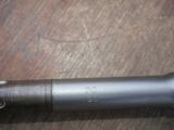 a close up of a metal pipe on a wooden table
