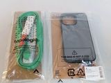 packaging for a cell phone with a green cord and a black case