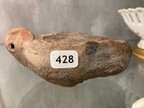 a stone bird that is sitting on a glass table