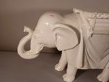 a white elephant statue that is sitting on a table
