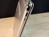a silver laptop on a wooden table with a black background