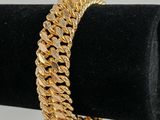 a gold bracelet on a black ring holder
