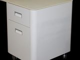 a white desk with two drawers on wheels on a black background