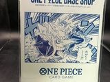 a box of one piece card game on display in a store