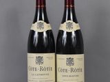 two bottles of wine sitting on top of a table