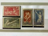 four different stamps are displayed in a display case on a table