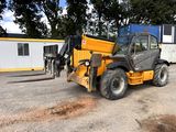 a yellow dump truck parked in front of a building