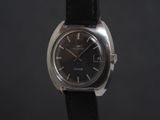 a close up of a watch on a black background