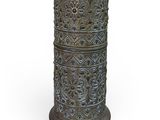 an image of a tall metal vase sitting on top of a white surface