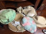 many hats that are sitting on a table