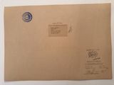 an envelope with a stamp on it sitting on top of a table