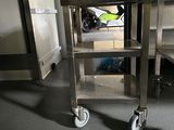 a metal cart with wheels in a room