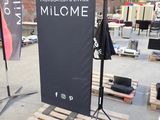 a sign that says milcome in front of a pallet
