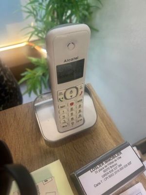 a cell phone sitting on top of a wooden table
