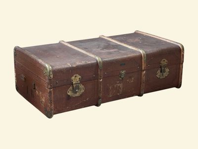 a brown trunk sitting on top of a table