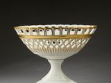 white and gold glass bowl with gold trim on pedestal