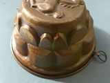 a cake tin with a bird on it sitting on a table