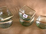 three glass cups sitting on a table with a price tag on them