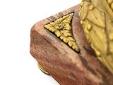 a statue of a bird on a wooden base