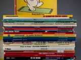 many children ' s books stacked on top of each other