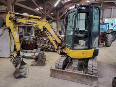 a yellow excavator that is parked in a building