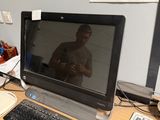 a computer monitor sitting on a desk with a keyboard and mouse