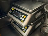 a digital scale sitting on top of a metal counter