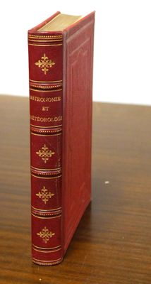 a red book sitting on top of a wooden table