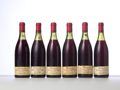 six bottles of wine lined up in a row on a table