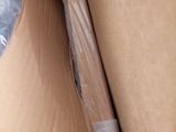 a cardboard box with a plastic wrap and a plastic object in it